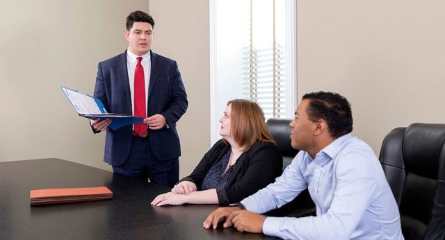 Attorney Marcus Priest speaking with clients