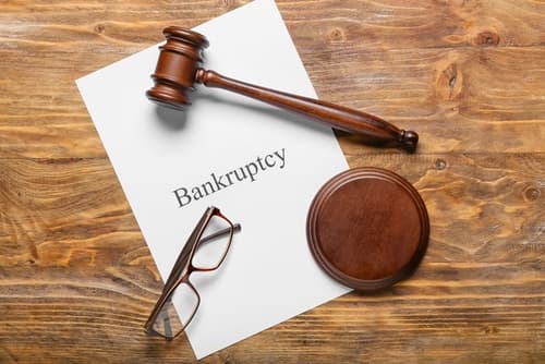 gavel and glasses on desk with bankruptcy paper