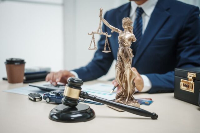 A lawyer in a suit sells cars at his desk, 